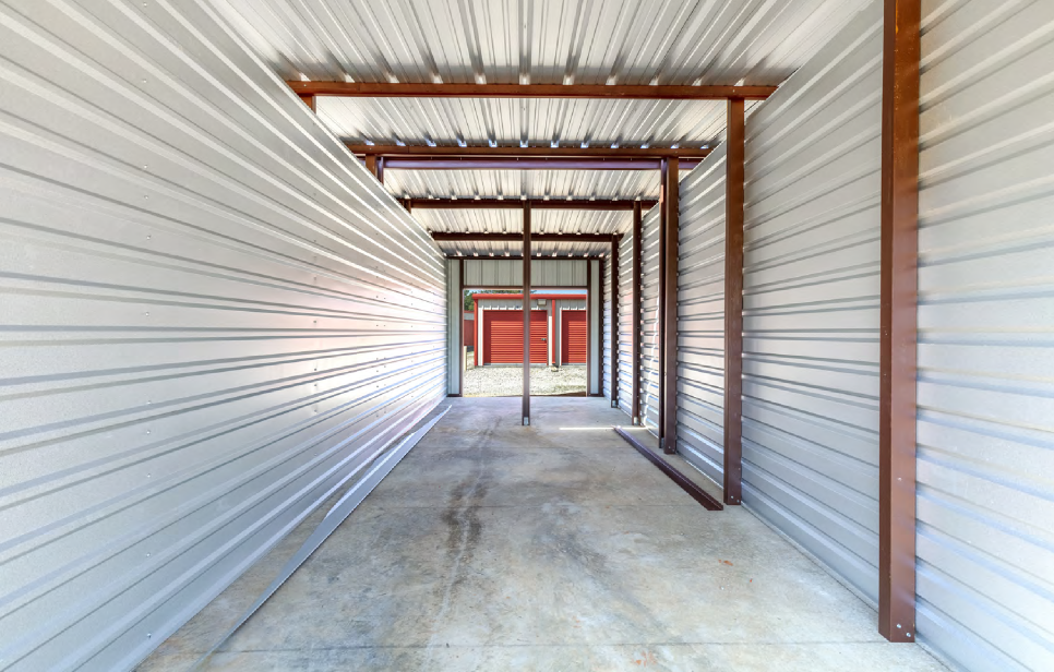 New Covered Storage Unit for RVs & Boats | Athens Secure Storage in Athens, TX Interior view of a newly constructed covered storage unit with metal framing at Athens Secure Storage & Parking in Athens, TX, ideal for RV or boat storage.
